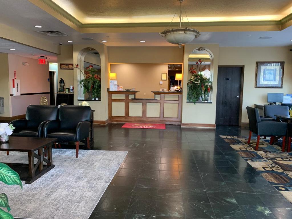 a lobby of a hospital with chairs and a table at Econo Lodge in Wesley Chapel
