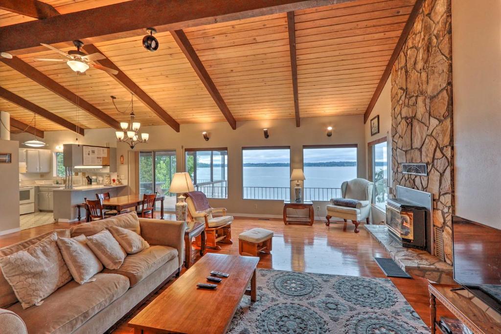 a living room with a couch and a table at Quiet Beachfront Family Home with Mt Rainier Views! in Shelton