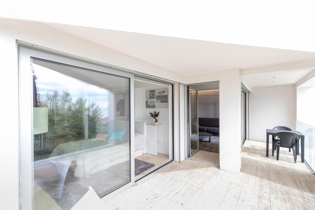 an open living room with sliding glass doors at Mont des Olives - Cap D'ail- app4 in Saint-Antoine