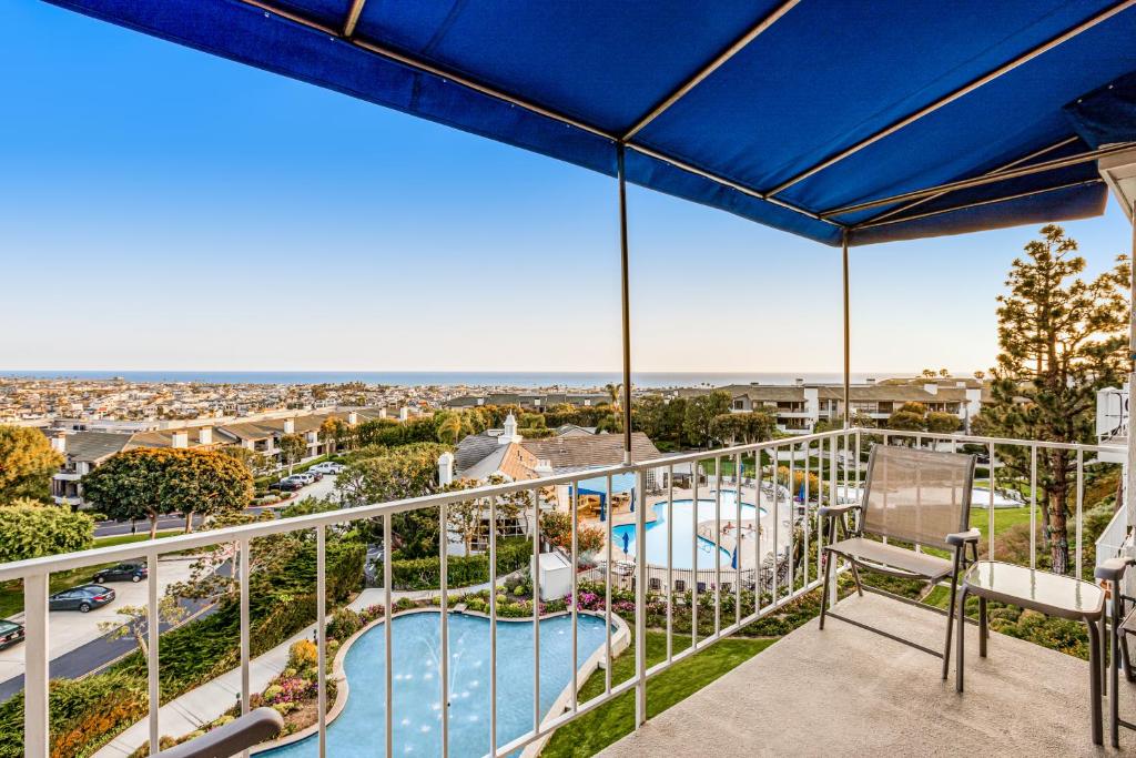 a balcony with a view of a pool at I Only Have Eyes for You in Newport Beach
