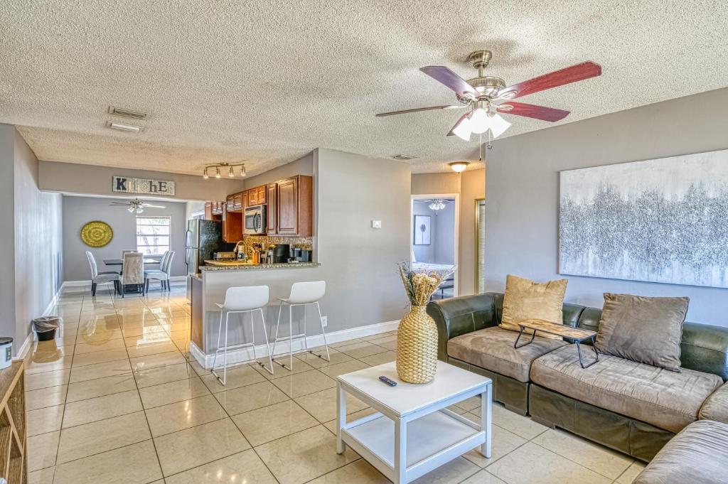 Una sala de estar con un sofá y un ventilador de techo. en Deerfield Delight, en Deerfield Beach