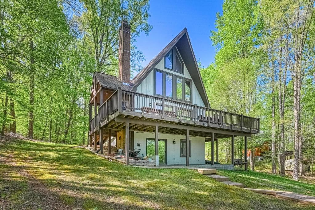 a house in the woods with a wrap around porch at Sweet Retreat in Bumpass