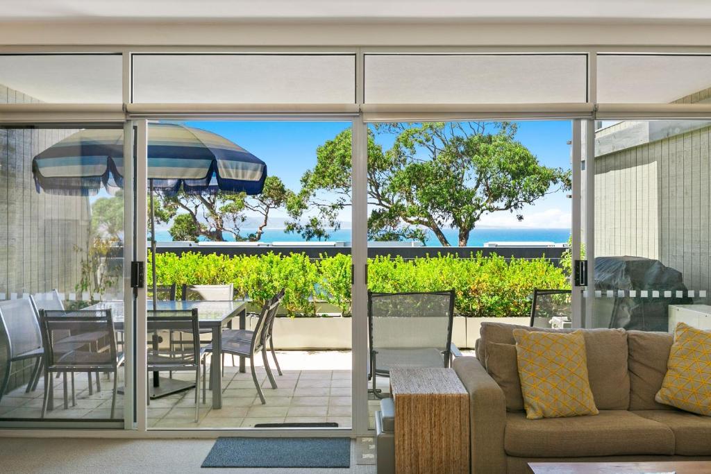 a living room with a couch and a table and chairs at Apartment 20 Kalimna in Lorne