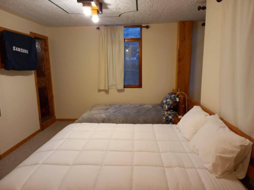 Postel nebo postele na pokoji v ubytování Bonanza Hospedaje