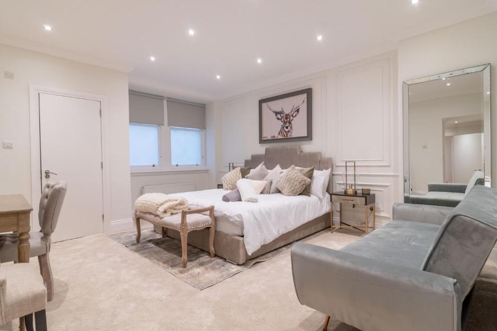 a bedroom with a bed and a living room at Large Blythswood Residence in Glasgow