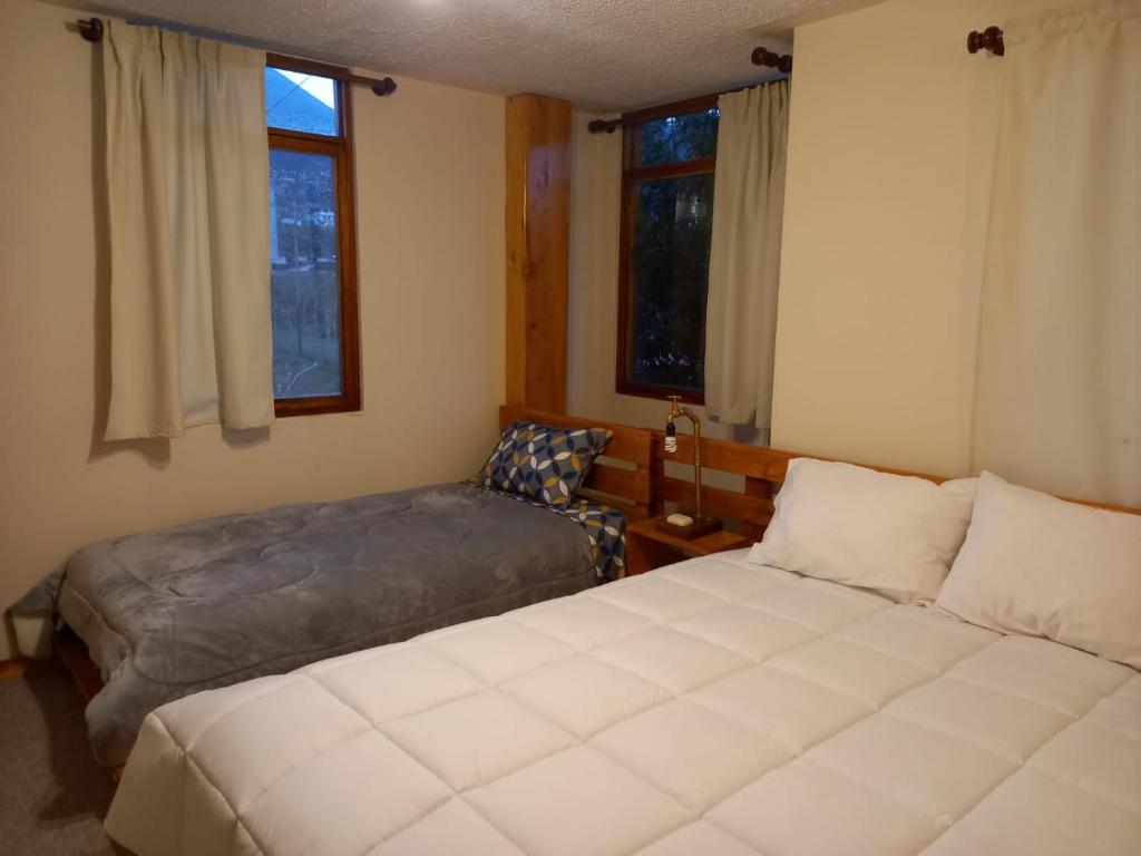 Postel nebo postele na pokoji v ubytování Bonanza Hospedaje