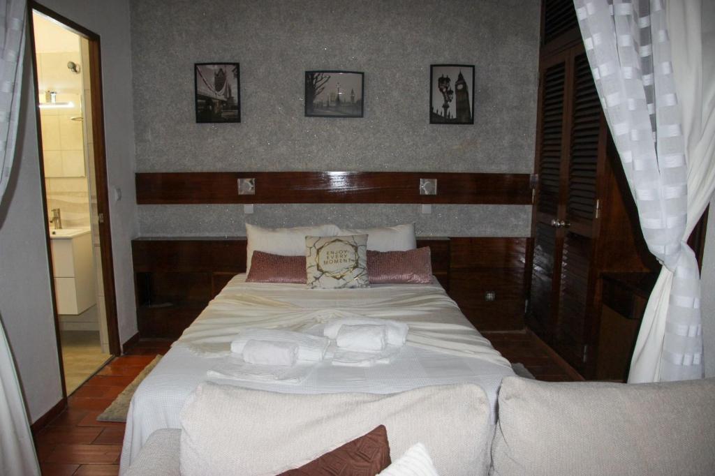 a bedroom with a large white bed with two pillows at Marina 2 in Vilamoura