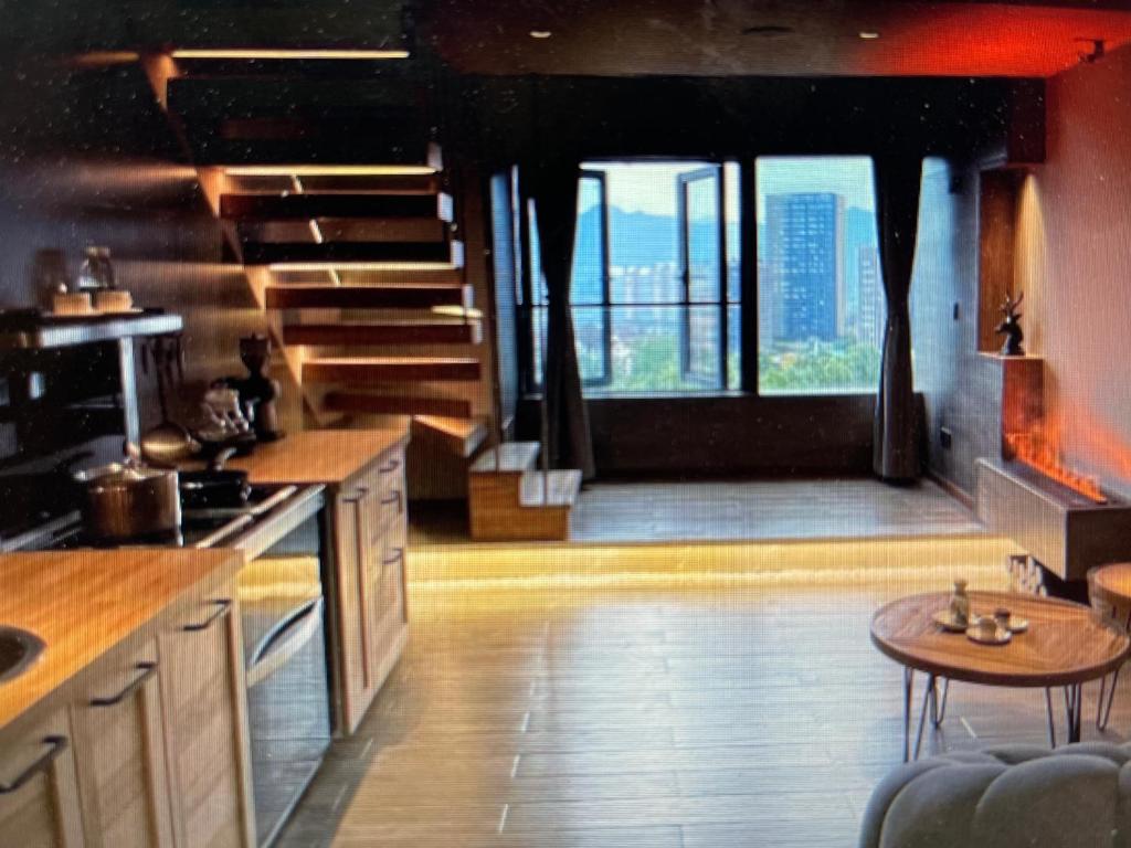 a large kitchen with a view of a city skyline at Zac Homestay in Chongqing
