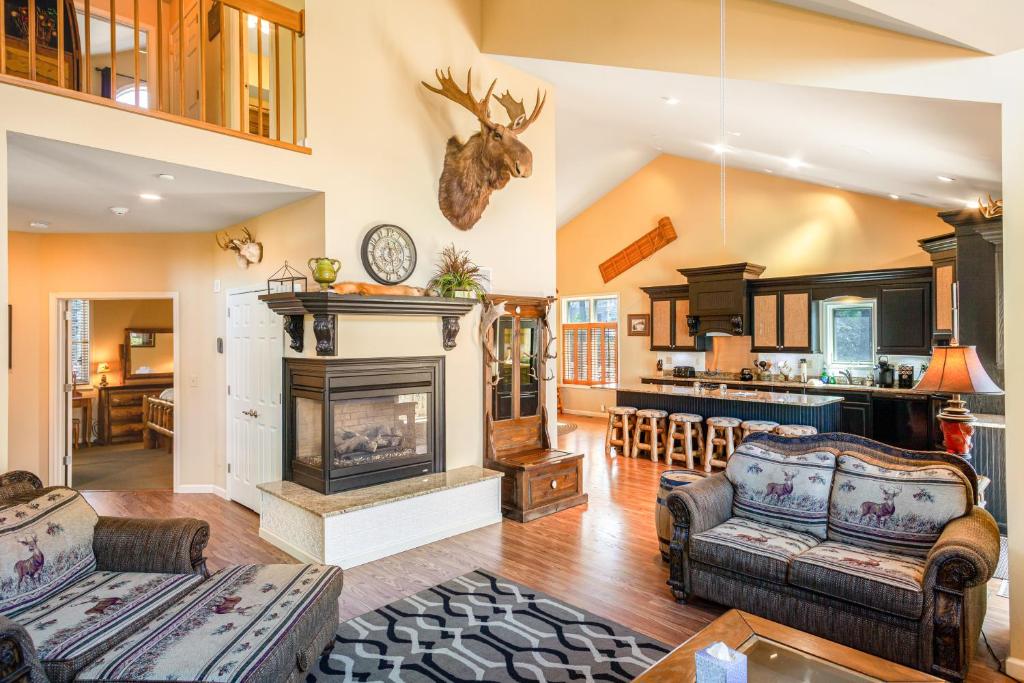 a living room with a fireplace and a kitchen at Kelto Kabin in Lake Harmony