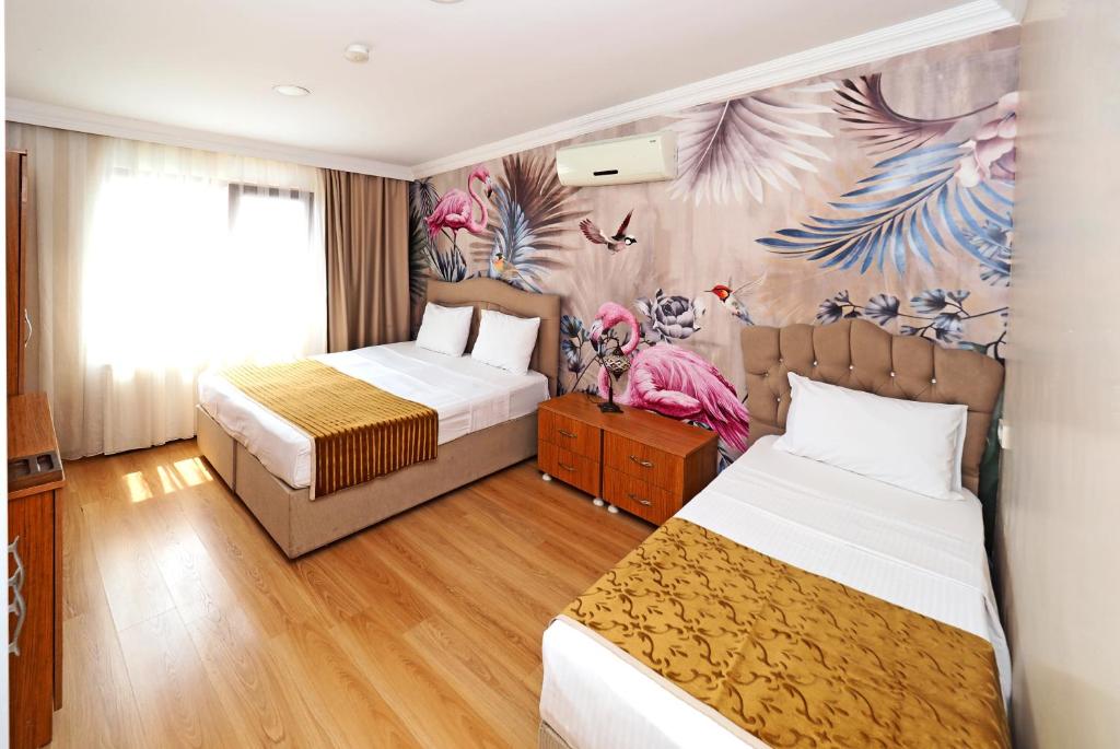 a hotel room with two beds and a mural at Seyri Istanbul Hotel in Istanbul