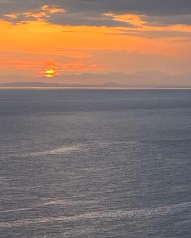 a sunset over a large body of water at B&B Is Pranus a Mari Casa Privata in Solanas