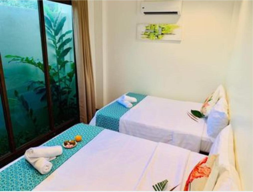 Postel nebo postele na pokoji v ubytování The Orient Beach Boracay