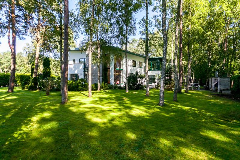 a house in the middle of a yard with trees at Villa in Tallinn near beach in Tallinn
