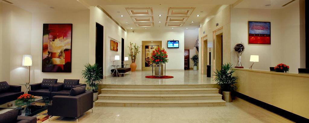 a lobby with stairs and couches in a building at Fortune Inn Sree Kanya, Visakhapatnam - Member ITC's Hotel Group in Visakhapatnam