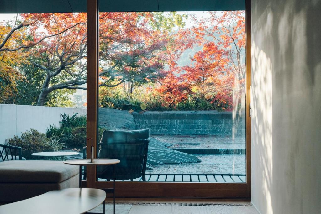 a room with a window with a view of a fountain at MUNI KYOTO by Onko Chishin in Kyoto