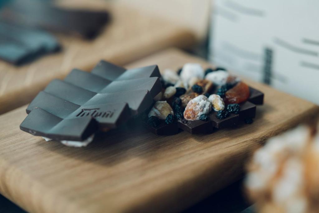 a bunch of chocolate treats on a wooden table at MUNI KYOTO by Onko Chishin in Kyoto