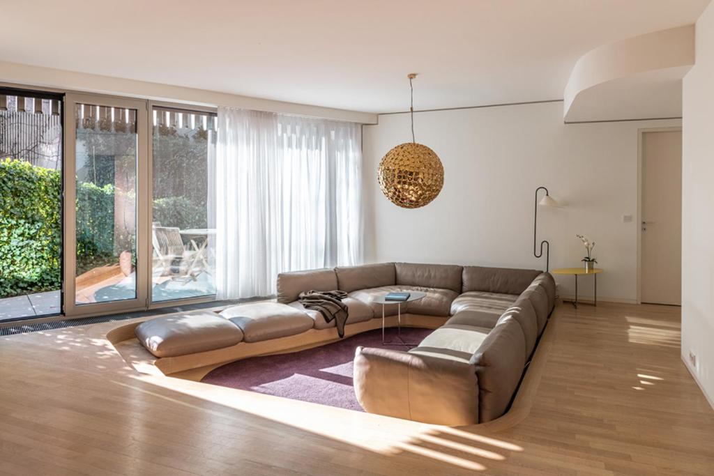 a living room with a brown couch and a table at Luxury Apartment Berlin Mitte in Berlin