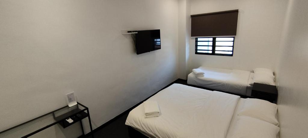 Postel nebo postele na pokoji v ubytování Olive Bedz Hotel