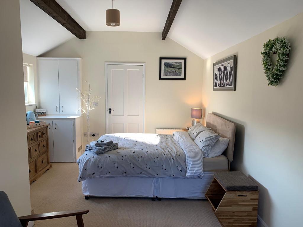 a bedroom with a bed and a table in it at Counting Sheep in Great Longstone