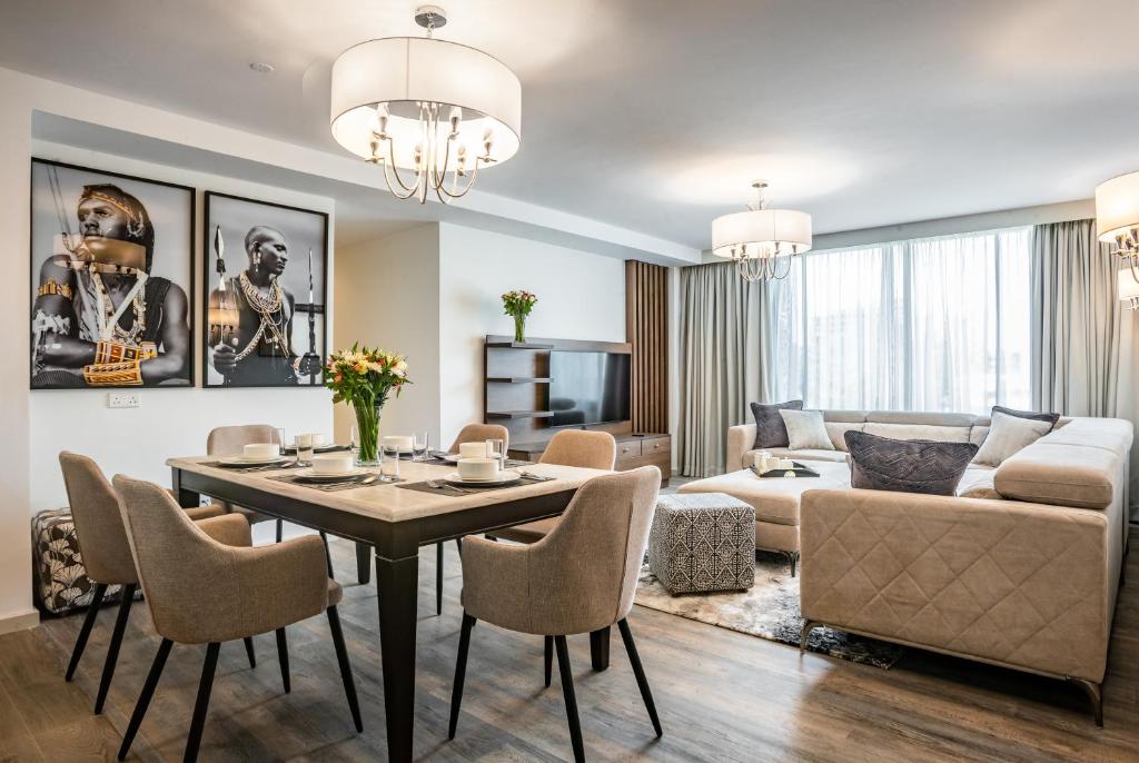 a living room with a table and chairs and a couch at Yaya Hotel & Apartments in Nairobi