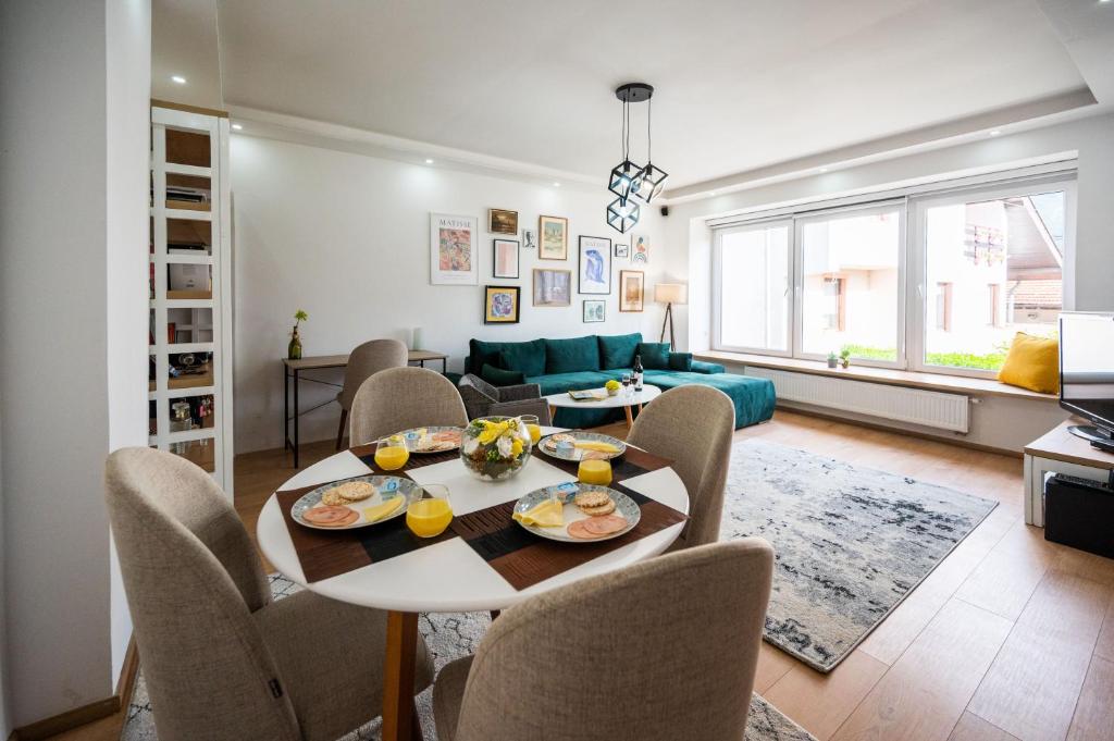 a dining room and living room with a table and chairs at Spacious and Bright 2BDR Apartment in the Old Town in Sarajevo