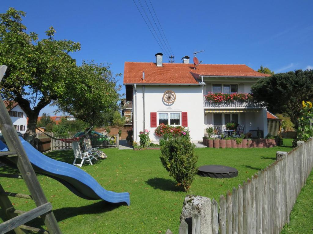 a house with a blue slide in the yard at Gästehaus Reisacher - Einzelzimmer in Peiting