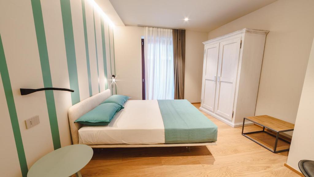 Ένα ή περισσότερα κρεβάτια σε δωμάτιο στο Vietti Apartments