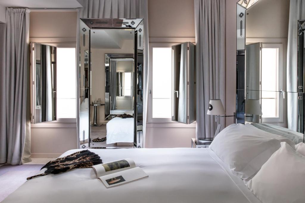 a bedroom with a bed and a large mirror at Hotel Palazzina Grassi in Venice