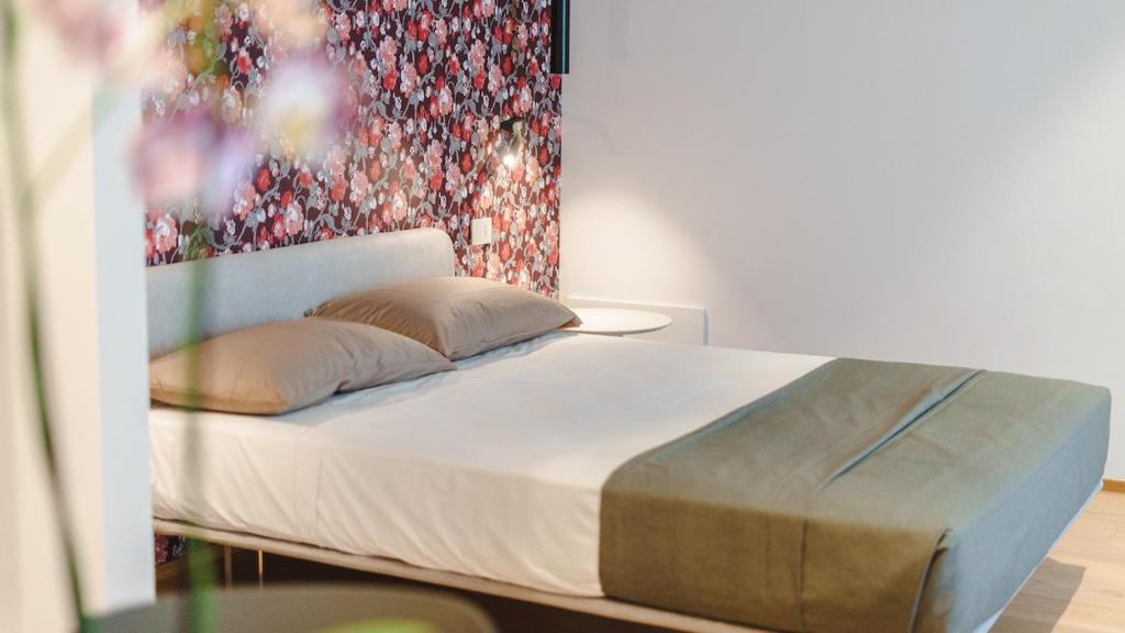 Ένα ή περισσότερα κρεβάτια σε δωμάτιο στο Vietti Apartments