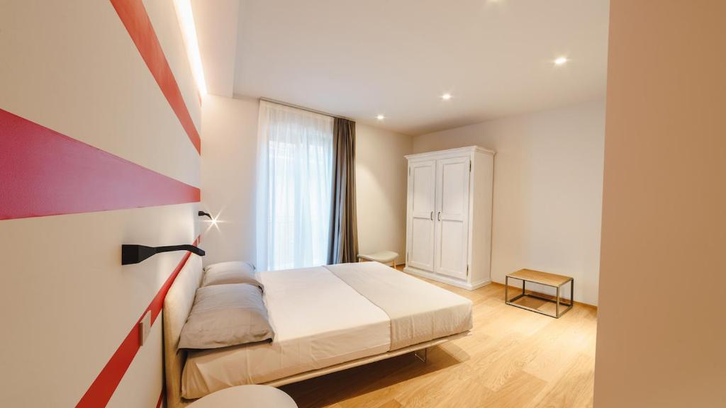Ένα ή περισσότερα κρεβάτια σε δωμάτιο στο Vietti Apartments