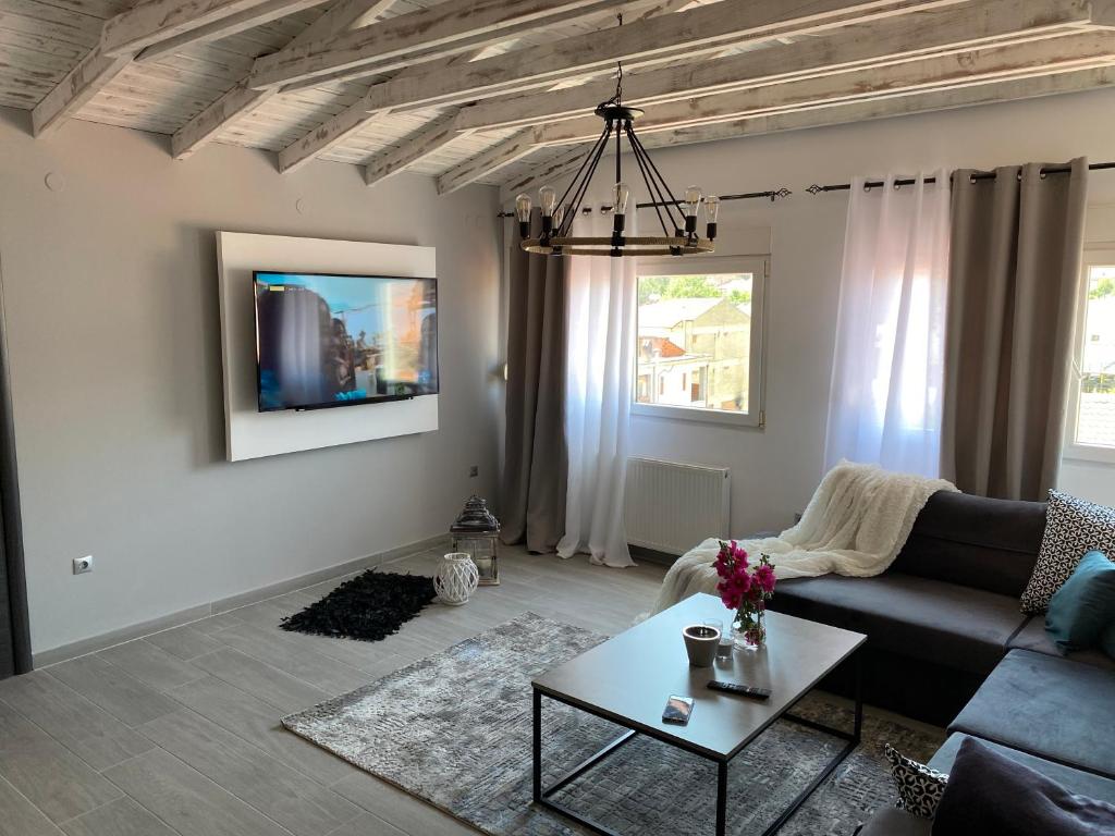 a living room with a couch and a table at Florina Sky Loft in Florina