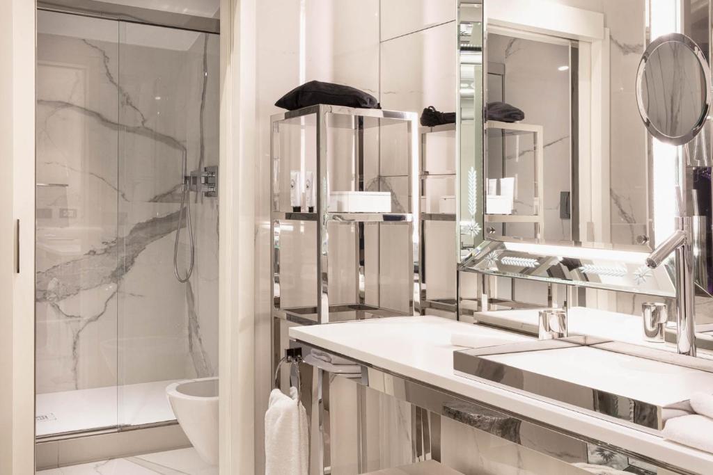 a white bathroom with two sinks and a shower at Hotel Palazzina Grassi in Venice
