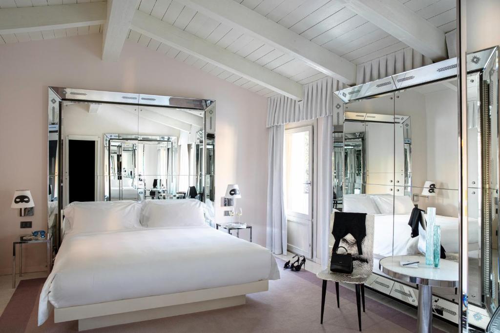 a hotel room with a large bed and a large mirror at Palazzina Grassi in Venice