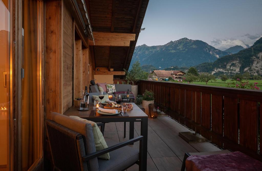 a balcony with a table and a view of mountains at SALZANO Apartments in Interlaken