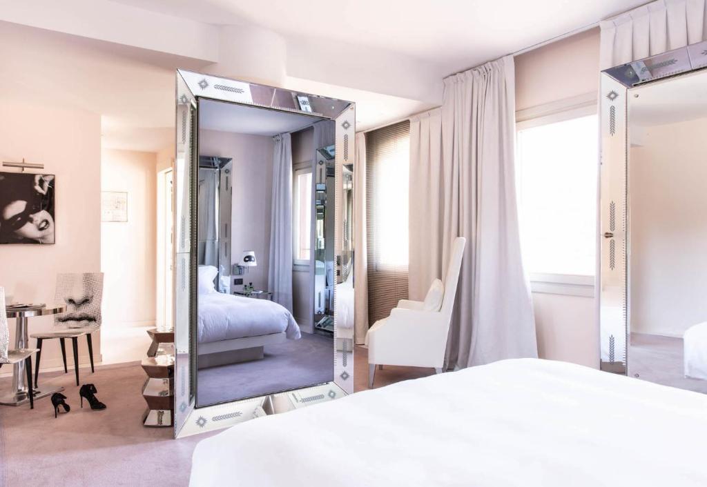 a bedroom with a large mirror in front of a bed at Hotel Palazzina Grassi in Venice