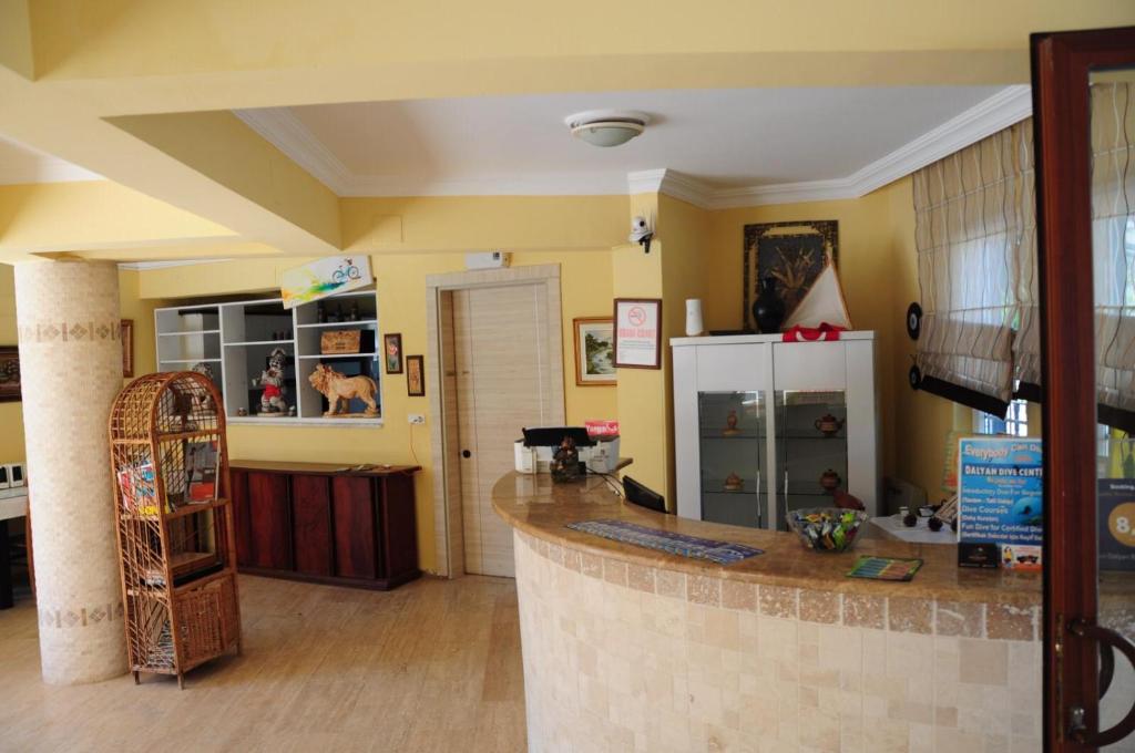a kitchen with a counter and a refrigerator in a room at EON DALYAN BOUTIQIE HOTEL in Ortaca
