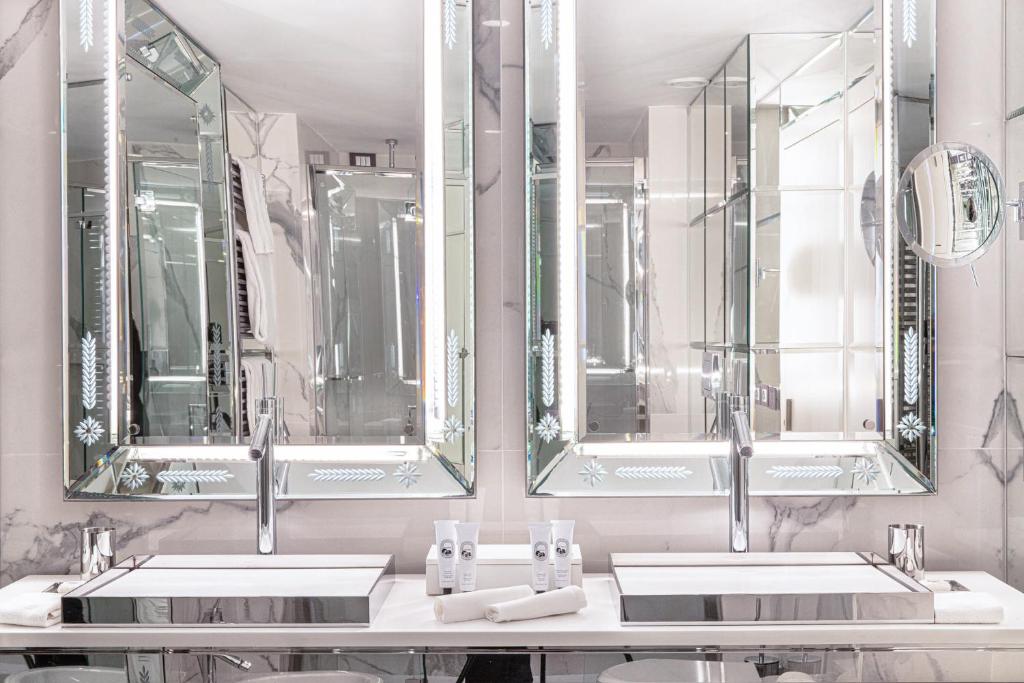 a bathroom with two sinks and two mirrors at Hotel Palazzina Grassi in Venice