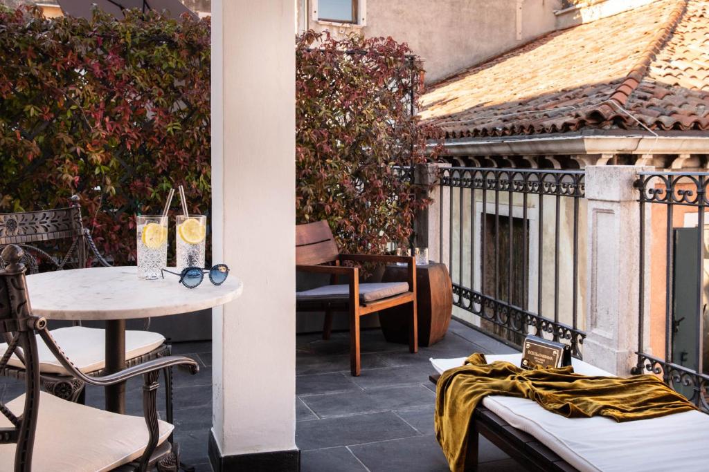 a patio with a table and chairs and a building at Hotel Palazzina Grassi in Venice