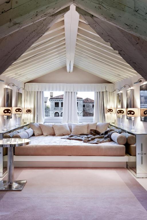 a large couch in a room with a large window at Hotel Palazzina Grassi in Venice