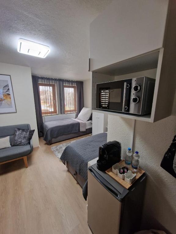 a small room with a bed and a couch at Unique Messe - Airport in Steinenbronn