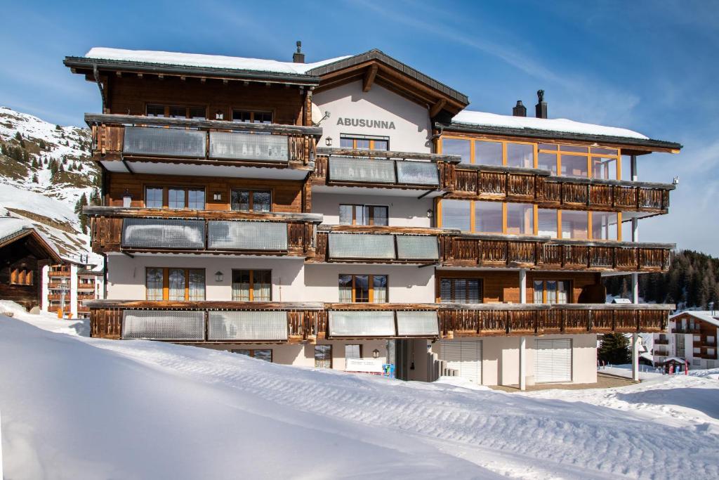 a building with snow in front of it at Abusunna Penthouse in Riederalp