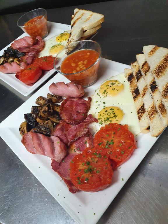 a plate of food with meat and vegetables and bread at Sensi Hotel in Marsaskala