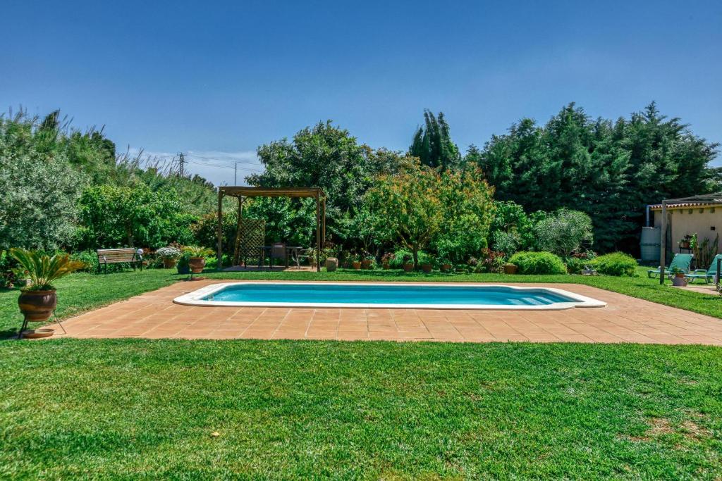 a swimming pool in a yard with a gazebo at Castell del Montgrí Rural in Torroella de Montgrí