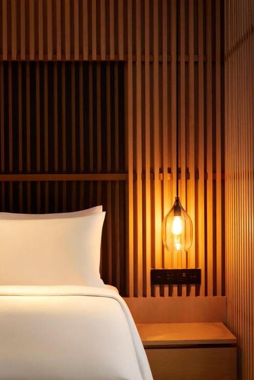 Postel nebo postele na pokoji v ubytování Park Hyatt Jakarta