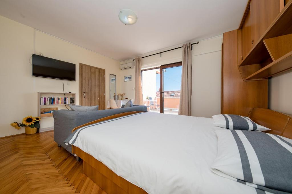 Postel nebo postele na pokoji v ubytování Apartments Tartuga