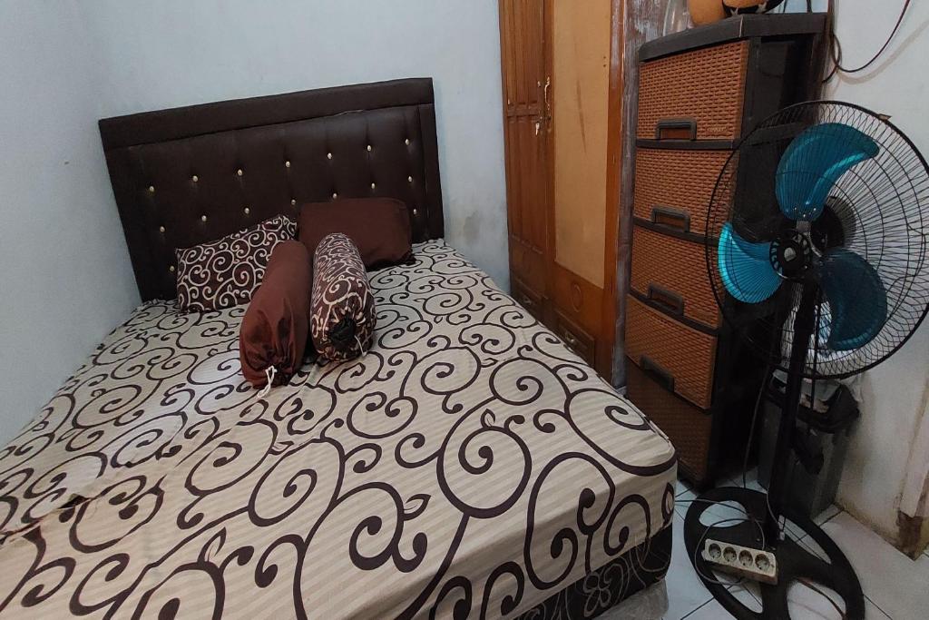 Un pat sau paturi într-o cameră la OYO HOMES 91255 Desa Wisata Embung Purworejo Syariah