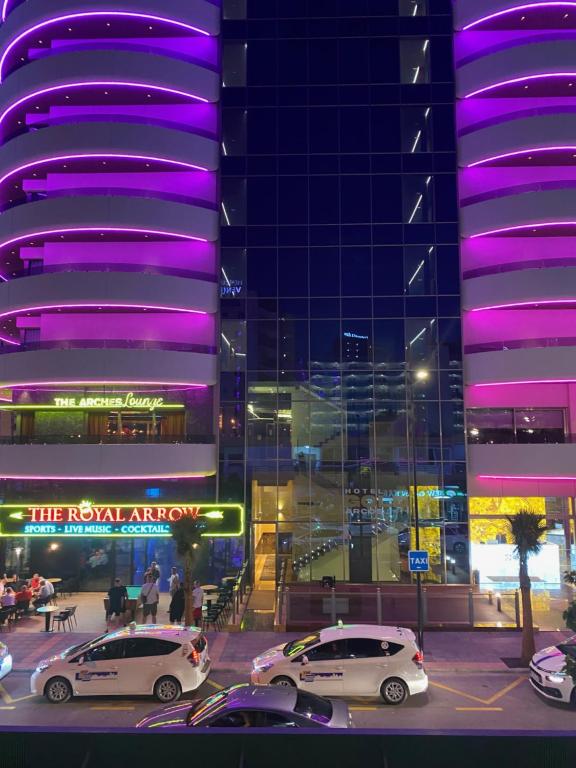 two cars parked in a parking lot in front of a building at 17 Calle Lepanto in Benidorm