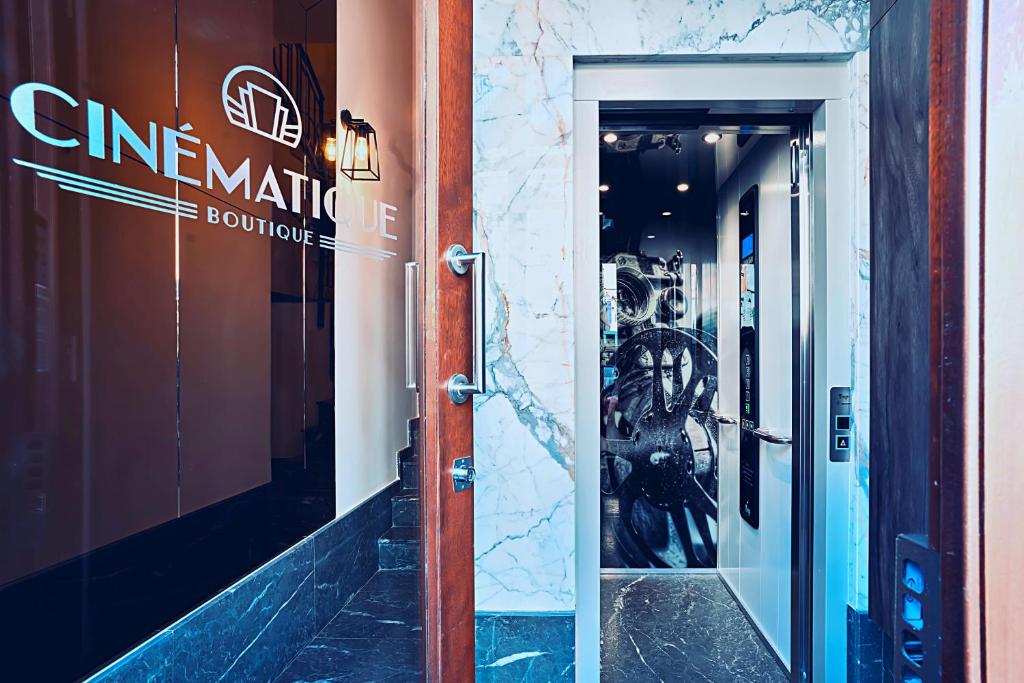 a door to a store with a sign on it at Cinematique in Mosta