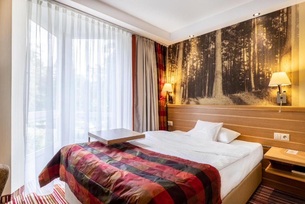 Postel nebo postele na pokoji v ubytování Hotel Warszawa Spa & Resort