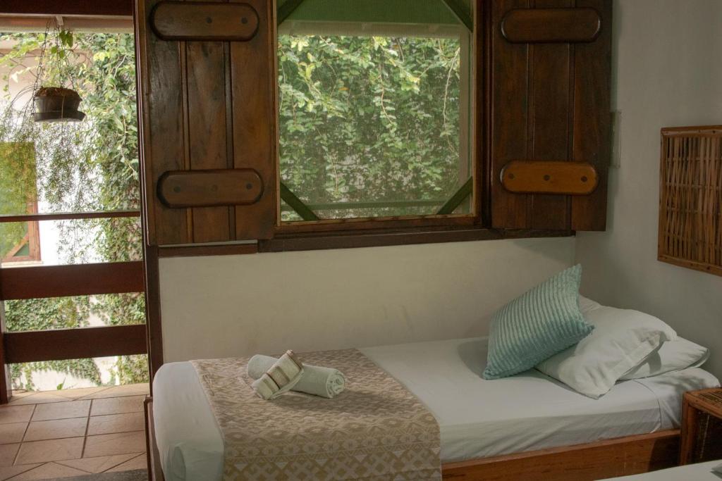 Cama ou camas em um quarto em Pousada Lanai